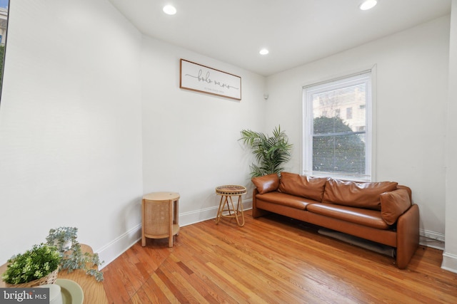 sitting room with baseboards, light wood-type flooring, and recessed lighting