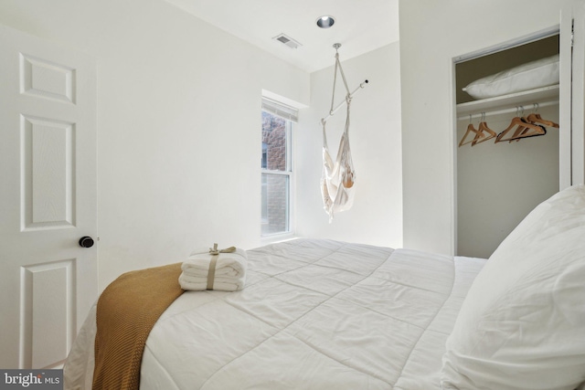 bedroom featuring a closet and visible vents