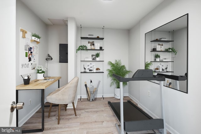 interior space with electric panel, light wood-style flooring, and baseboards