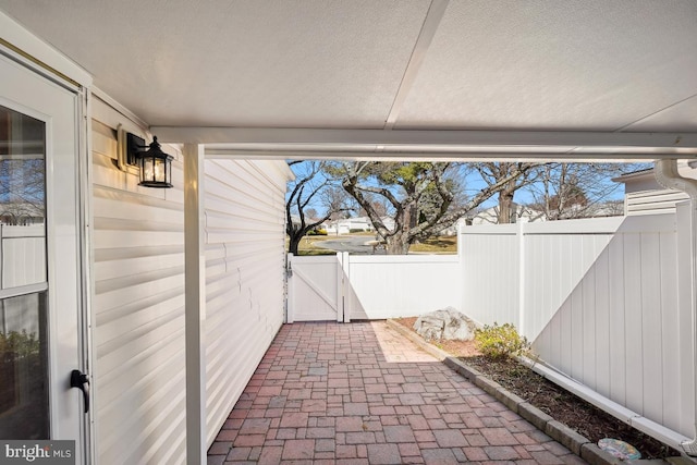 view of patio / terrace featuring fence and a gate