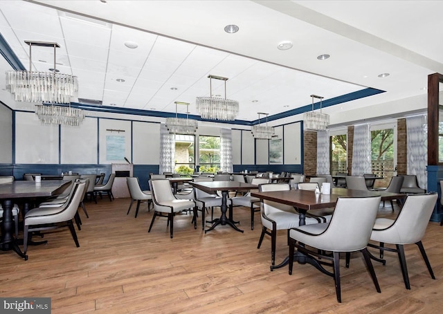 dining space with wood finished floors and a chandelier