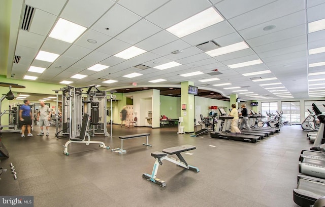 exercise room with a drop ceiling and visible vents