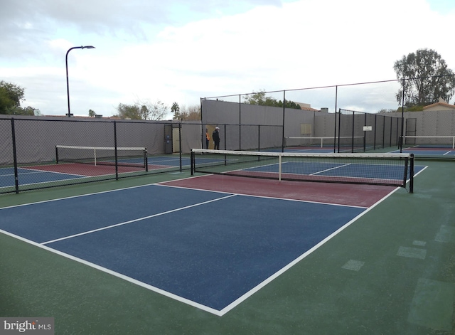 view of tennis court featuring fence