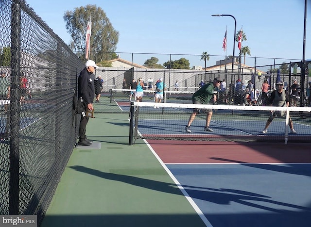 view of sport court featuring fence