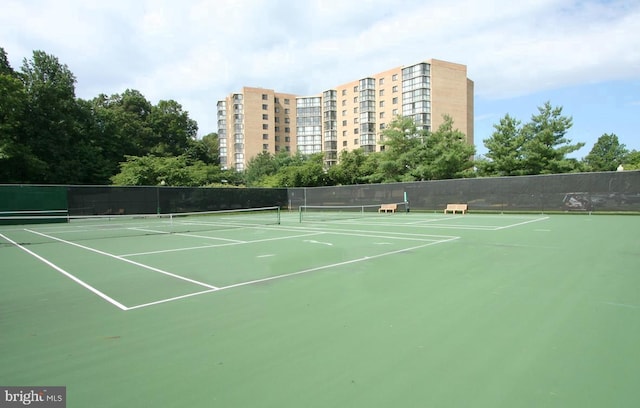 view of sport court featuring fence