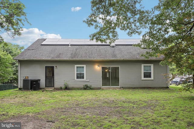 9303 Foxcroft Ave, Clinton, MD 20735 - back of property featuring roof with shingles, a lawn, cooling unit, and solar panels