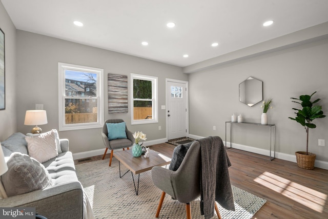 living room featuring recessed lighting, dark wood-style flooring, and baseboards