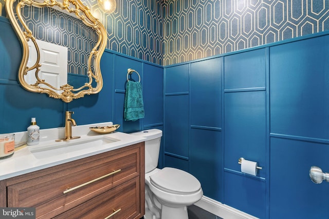 bathroom featuring toilet and vanity