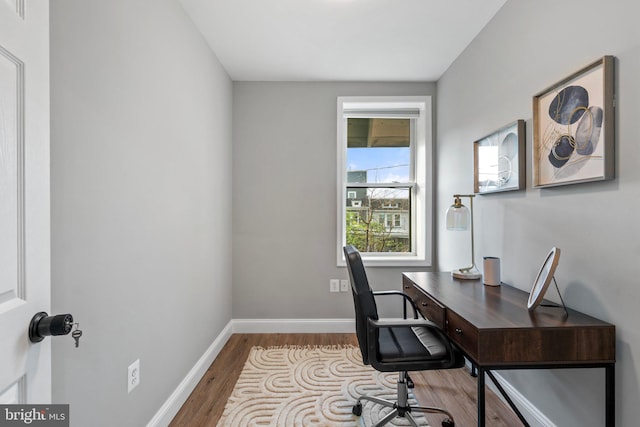 office space with wood finished floors and baseboards