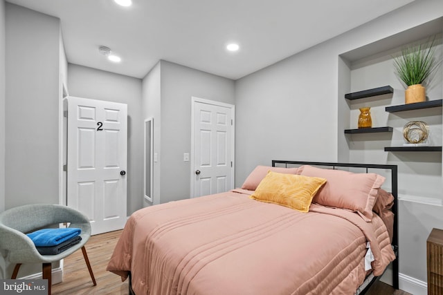 bedroom featuring wood finished floors and recessed lighting