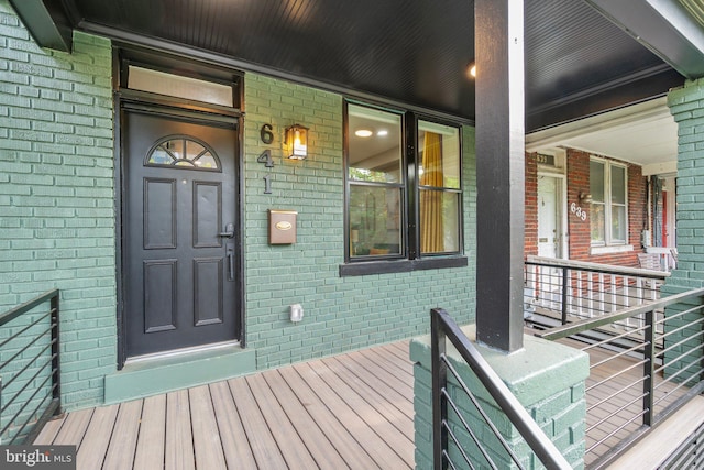 view of exterior entry featuring brick siding