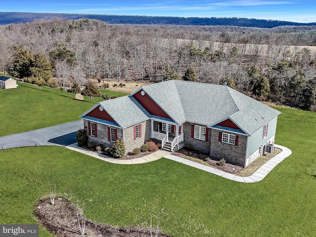 birds eye view of property with a forest view