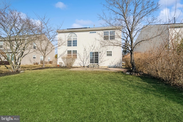 rear view of property with a yard