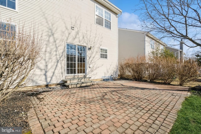 rear view of property with entry steps and a patio area