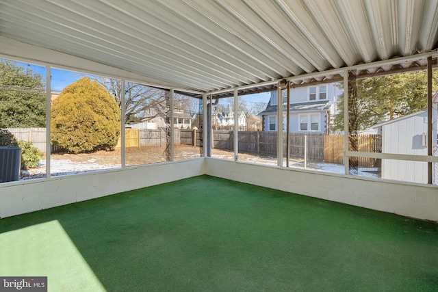 unfurnished sunroom featuring plenty of natural light and a residential view