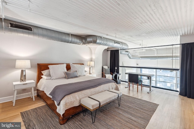 bedroom featuring wood finished floors and baseboards