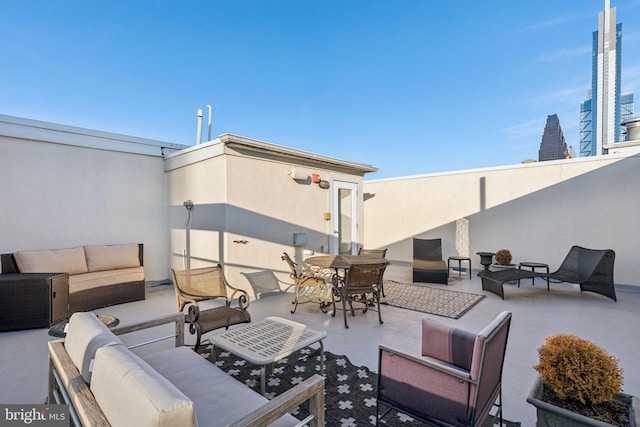 view of patio / terrace featuring a view of city and an outdoor hangout area