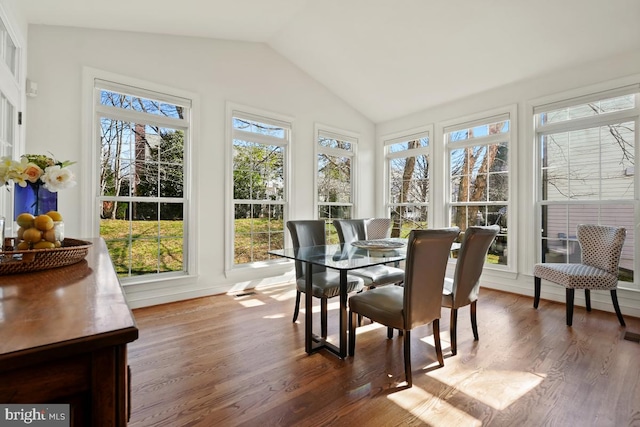 sunroom featuring vaulted ceiling and a healthy amount of sunlight