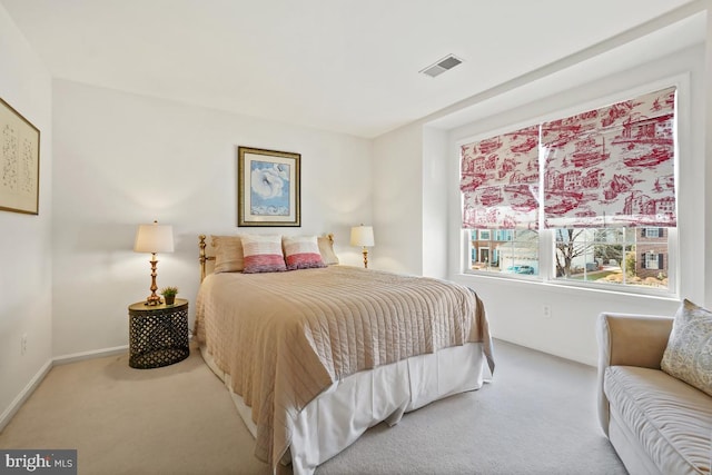 bedroom with carpet floors, visible vents, and baseboards