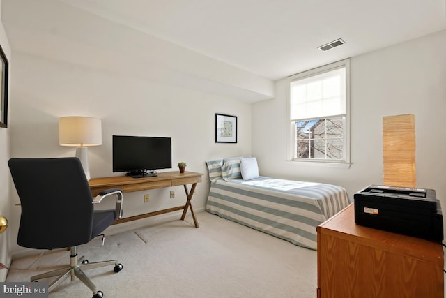 carpeted bedroom featuring visible vents and baseboards