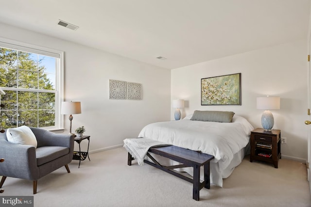 bedroom with light carpet, baseboards, and visible vents