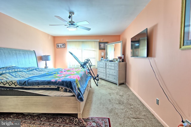 bedroom featuring a ceiling fan, light carpet, and baseboards