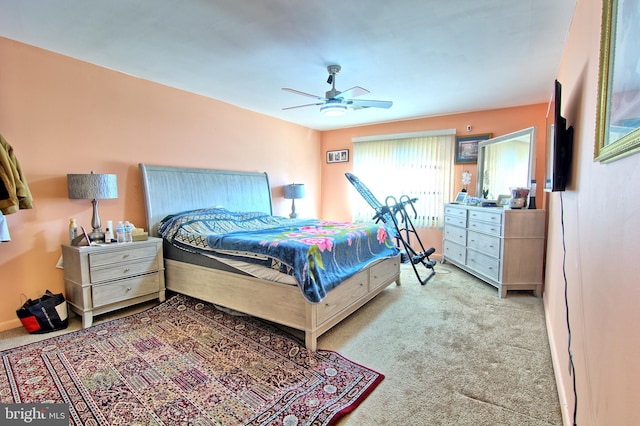 bedroom with light carpet and a ceiling fan