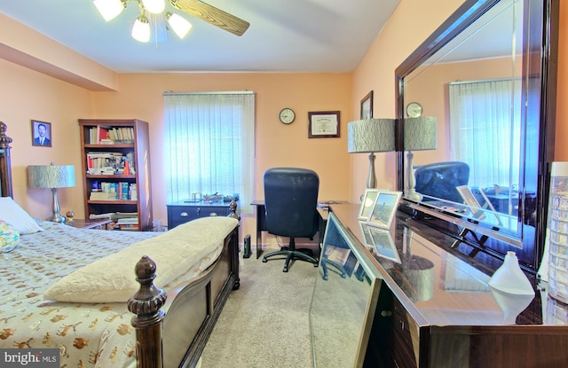 bedroom with ceiling fan and light colored carpet