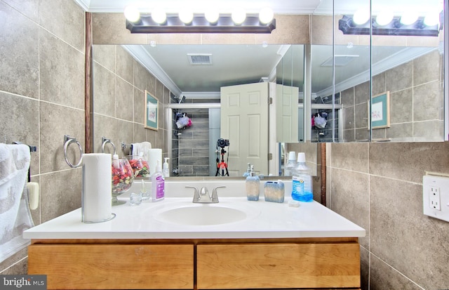 full bath featuring visible vents, tile walls, crown molding, and vanity