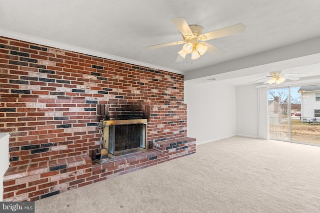 unfurnished living room featuring ceiling fan, carpet floors, a fireplace, baseboards, and crown molding