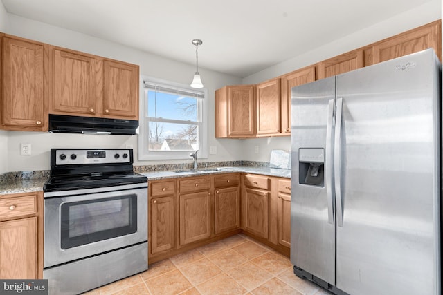 kitchen featuring under cabinet range hood, stainless steel appliances, a sink, hanging light fixtures, and light stone countertops