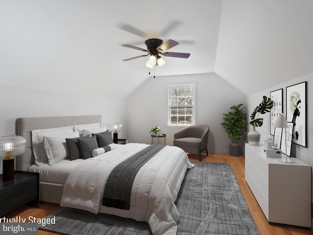 bedroom with a ceiling fan, vaulted ceiling, and light wood-style flooring