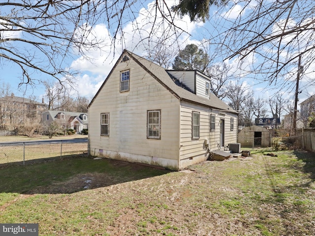 view of home's exterior featuring crawl space, fence, central AC unit, and a yard