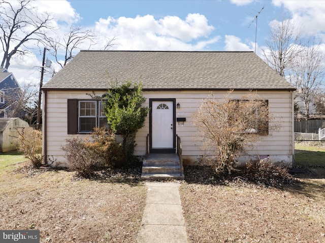 bungalow with roof with shingles and fence