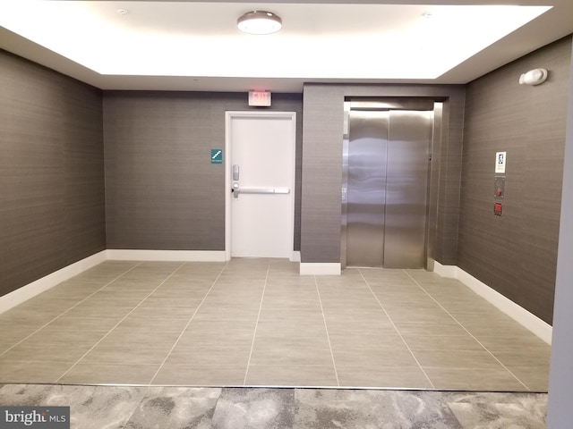 989 S Buchanan St Unit 320, Arlington, VA 22204 - interior space featuring elevator, light tile patterned flooring, and baseboards