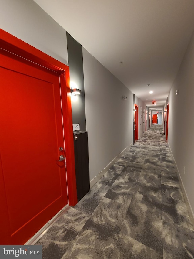 989 S Buchanan St Unit 320, Arlington, VA 22204 - hallway featuring dark colored carpet and baseboards