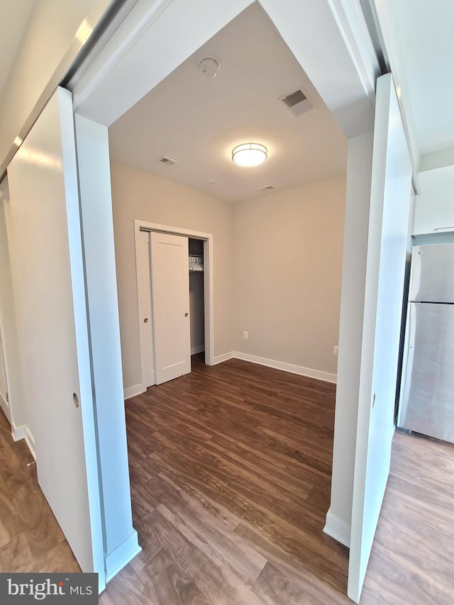989 S Buchanan St Unit 320, Arlington, VA 22204 - hall with baseboards, visible vents, and wood finished floors