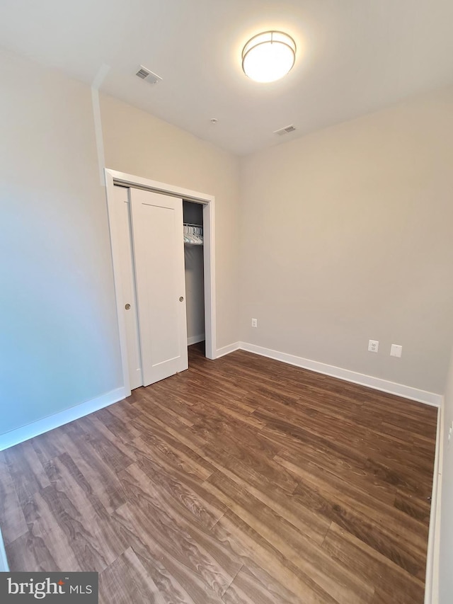 989 S Buchanan St Unit 320, Arlington, VA 22204 - unfurnished bedroom with a closet, visible vents, baseboards, and wood finished floors
