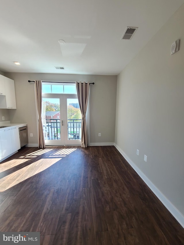 989 S Buchanan St Unit 320, Arlington, VA 22204 - unfurnished living room featuring dark wood-style floors, french doors, visible vents, and baseboards