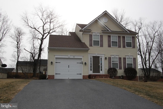 view of front facade featuring a garage and aphalt driveway