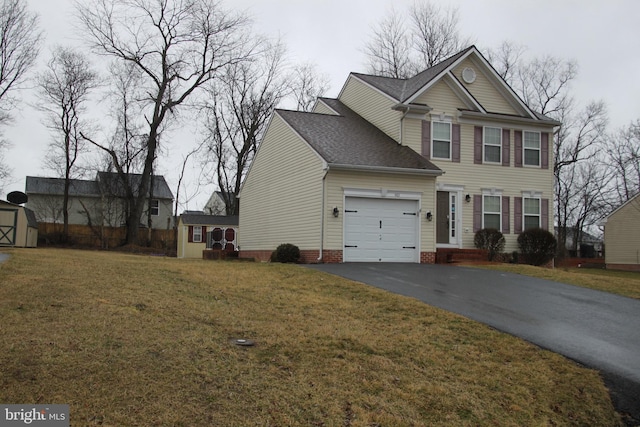 view of front facade featuring an outbuilding, a garage, a storage shed, driveway, and a front yard