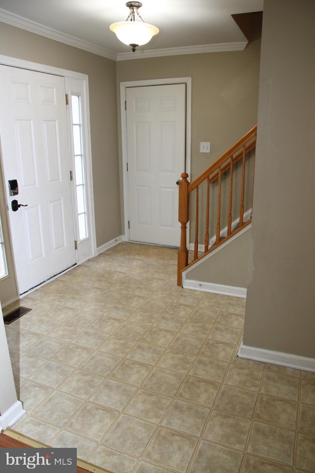 entryway featuring baseboards, visible vents, stairway, and crown molding