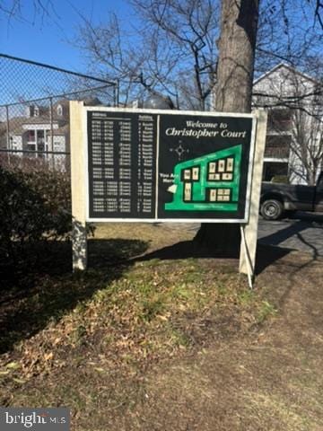 view of home's community featuring fence