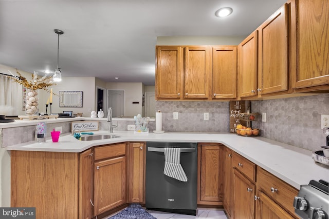 kitchen with dishwasher, backsplash, light countertops, pendant lighting, and a sink