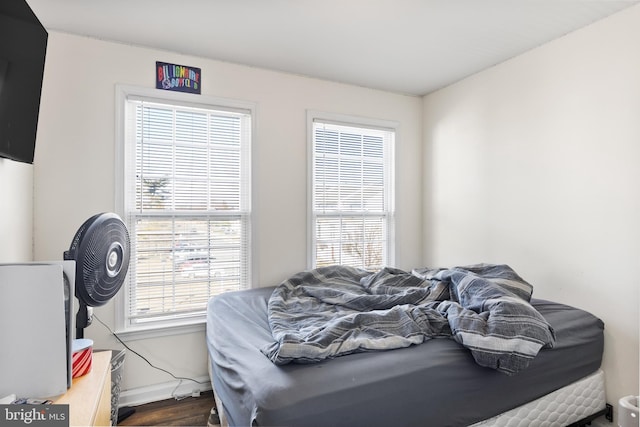 bedroom featuring dark wood-type flooring and baseboards