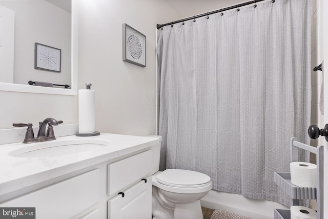 full bathroom with toilet and vanity