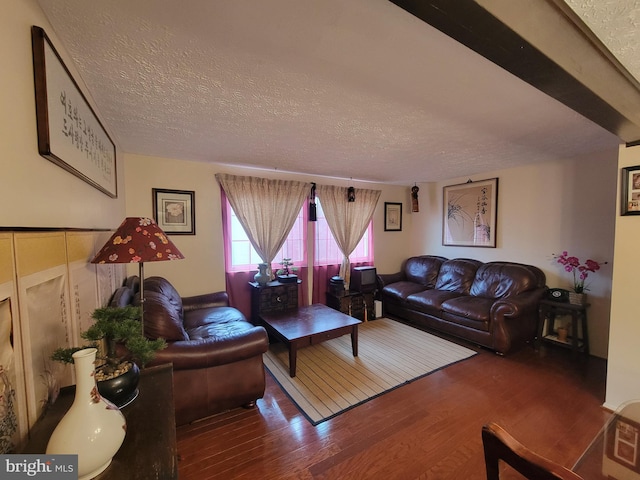 living area featuring a textured ceiling and wood finished floors