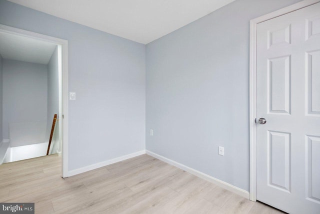 unfurnished bedroom featuring light wood-type flooring and baseboards