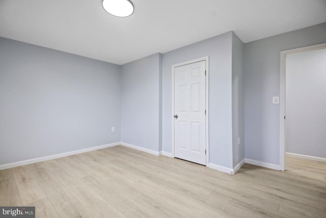 unfurnished bedroom featuring light wood-style flooring and baseboards