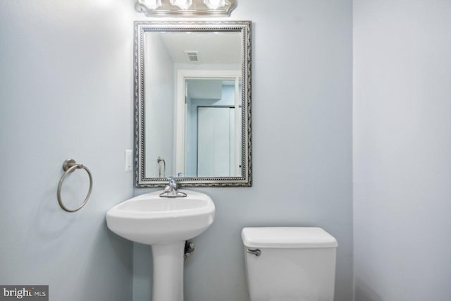 bathroom with toilet and visible vents